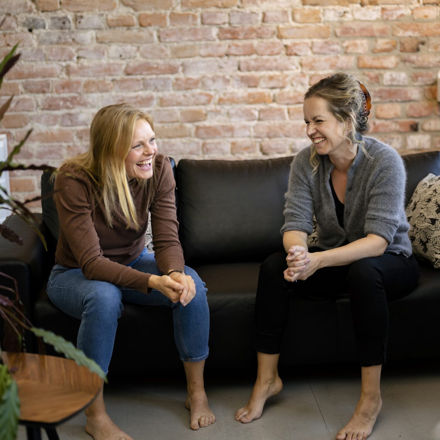 Linn och Johanna sitter i en soffa.